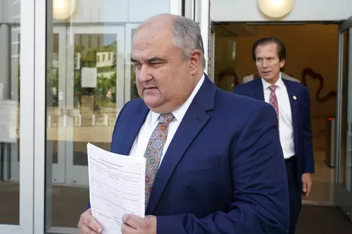 John Davis, former director of the Mississippi Department of Human Services, followed by his attorney Merrida Coxwell, right, leaves the Thad Cochran United States Courthouse in Jackson, Miss., Thursday, Sept. 22, 2022.  Davis pleaded guilty to new federal charges in a conspiracy to misspend tens of millions of dollars that were intended to help needy families in one of the poorest states in the U.S. — part of the largest public corruption case in the state's history.(AP Photo/Rogelio V. Solis
