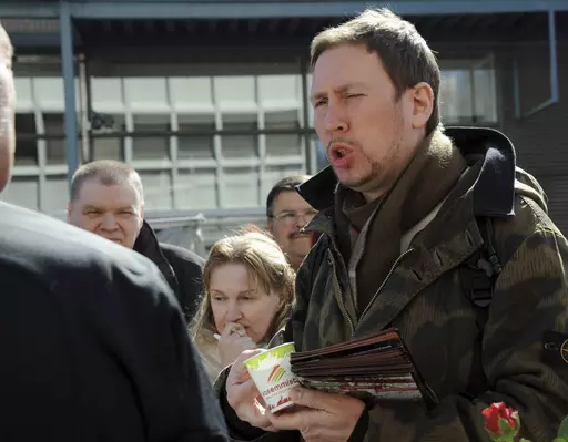 Paavo Arhinmaki, right, then leader of The Left Alliance and candidate for the Finnish Parliament, meets with voters during the party's election campaign in Helsinki, Finland, Saturday April 16, 2011. The current deputy mayor of Finland’s capital Arhinmaki is facing possible legal action, and calls for him to pay compensation for damages and to resign, after he was caught red-handed spray-painting graffiti in a railway tunnel on Friday, June 23, 2023. (Sari Gustafsson/Lehtikuva via AP, File)