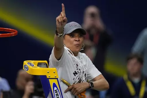 South Carolina head coach Dawn Staley cuts the net after a college basketball game in the final round of the Women's Final Four NCAA tournament against UConn, Sunday, April 3, 2022, in Minneapolis. Dawn Staley and South Carolina picked up right where they left off _ No. 1 in The Associated Press Top 25 women's basketball poll, Tuesday, Oct. 18. (AP Photo/Charlie Neibergall, File)