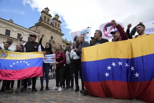 Venezuelans, who support opposition leader María Corina Machado, sing their native country's national anthem during a protest demanding free and fair elections in Venezuela's upcoming election, in Bolivar Square in Bogota, Colombia, April 6, 2024. Of the millions of Venezuelans who have fanned out around the world, including those who migrated before the economic crisis, only about 107,000 are registered to vote outside the South American country. (AP Photo/Fernando Vergara, File)