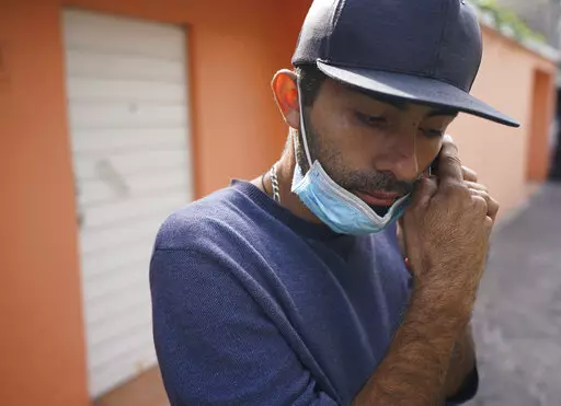 Jose Cuicas from Venezuela listens to an audio message on his phone outside of a migrant shelter in Mexico City, Thursday, Oct. 20, 2022. The mechanic is one of some 1,700 Venezuelans that U.S. authorities expelled to Mexico in the past week under a deal between the U.S. and Mexico to deny them the right to U.S. asylum and try to keep them from coming to the border. (AP Photo/Fernando Llano)