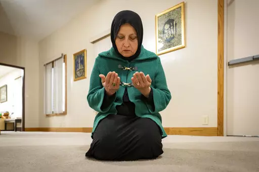 Bibi Bahrami prays at the Islamic Center of Muncie, Ind., on Friday, March 3, 2023, where she is one of the mosque's leaders. Bahrami is a subject of the documentary "Stranger at the Gate" that tells the story of the relationship she and others in their small Islamic community fostered with Richard McKinney, a former U.S. Marine who at one point had planned to bomb their community center. (AP Photo/Doug McSchooler)