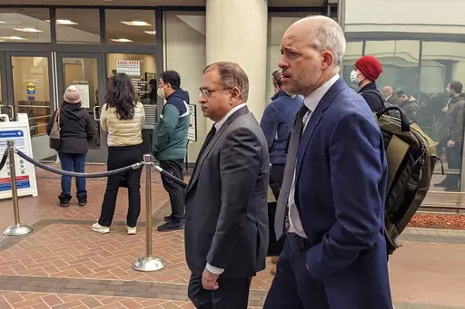 Former Theranos executive Ramesh "Sunny" Balwani, center, walkes to federal court with his attorney Mark Davies, Friday, Feb. 17, 2023 in San Jose, Calif. Balwani returned to federal court Friday in a last-ditch attempt to stay out of prison while he appeals a jury's verdict convicting him of deceiving investors and patients in a blood-testing hoax that he orchestrated with his former boss and lover, Elizabeth Holmes. (AP Photo/Michael Liedtke)