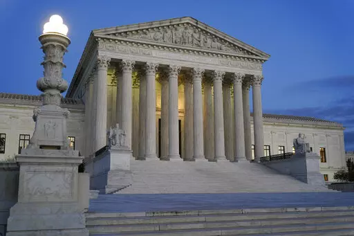Light illuminates part of the Supreme Court building at dusk on Capitol Hill in Washington, Nov. 16, 2022. The court is set to hear arguments Wednesday in a case from North Carolina, where Republican efforts to draw congressional districts heavily in their favor were blocked by a Democratic majority on the state Supreme Court because the GOP map violated the state constitution. (AP Photo/Patrick Semansky, File)