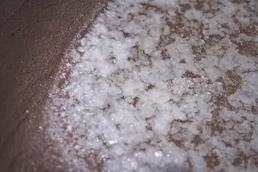 Salt begins to form in one of the dozens of salt beds in the Hanapepe salt patch on Kauai Island on Wednesday, July 12, 2023, in Hanapepe, Hawaii. This Native Hawaiian salt has been hand made for generations. And as a part of the culture and spiritual practice, it has always been given away or traded, but never sold. (AP Photo/Jessie Wardarski)
