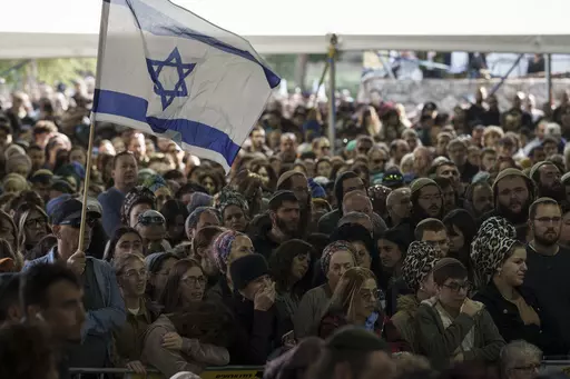 Mourners attend the funeral of Israeli staff sergeant Elisha Yehonatan Lober, who was killed in battle in the Gaza Strip, at the Mount Herzl military cemetery in Jerusalem, Israel, Wednesday, Dec. 27, 2023. (AP Photo/Leo Correa)