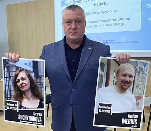 In this handout photo from the Viasna Human Rights Center, Leanid Sudalenka, an activist from Belarus, holds portraits of imprisoned journalists Larysa Shchyrakova and Yauhen Merkis, in Belostok, Poland, Sunday, Nov. 5, 2023. Sudalenka, who was imprisoned for three years in Belarus, said authorities there hold political prisoners in conditions amounting to "torture." He told The Associated Press that when he was in a Belarusian penal colony, he nearly died from COVID-19 and a lack of medical car