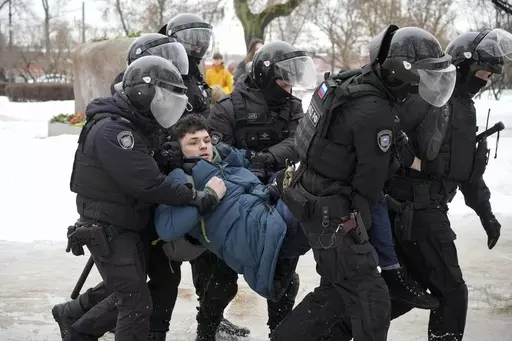 Police detain a man trying to lay flowers to honor Alexei Navalny at a monument in St. Petersburg, Russia, to victims of Soviet repression, on Saturday, Feb. 17, 2024. Over the last decade, Vladimir Putin's Russia evolved from a country that tolerates at least some dissent to one that ruthlessly suppresses it. Arrests, trials and long prison terms — once rare — are commonplace. (AP Photo, File)
