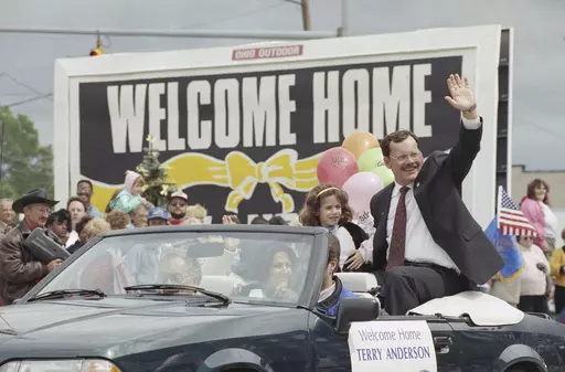 Former hostage Terry Anderson waves to the crowd as he rides in a parade in Lorain, Ohio, June 22, 1992. Anderson, the globe-trotting Associated Press correspondent who became one of America’s longest-held hostages after he was snatched from a street in war-torn Lebanon in 1985 and held for nearly seven years, died Sunday, April 21, 2024. He was 76. (AP Photo/Mark Duncan, File)
