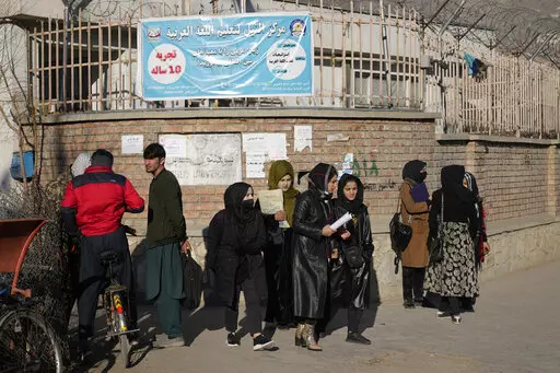 Afghan women students stand outside the Kabul University in Kabul, Afghanistan, on Dec. 21, 2022. The United Nations' human rights chief on Tuesday Dec. 27, 2022 decried increasing restrictions on women's rights in Afghanistan, urging the country's Taliban rulers to reverse them immediately. He pointed to “terrible consequences” of a decision to bar women from working for non-governmental organizations. (AP Photo/Ebrahim Noroozi, File)