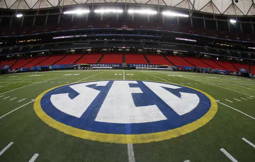 The SEC logo is displayed on the field ahead of the Southeastern Conference championship football game between Alabama and Missouri on Dec. 5, 2014, in Atlanta. Southeastern Conference leaders will continue debating what to do with their football schedule when they meet in the Florida Panhandle starting Tuesday, May 30, 2023. (AP Photo/John Bazemore, File)