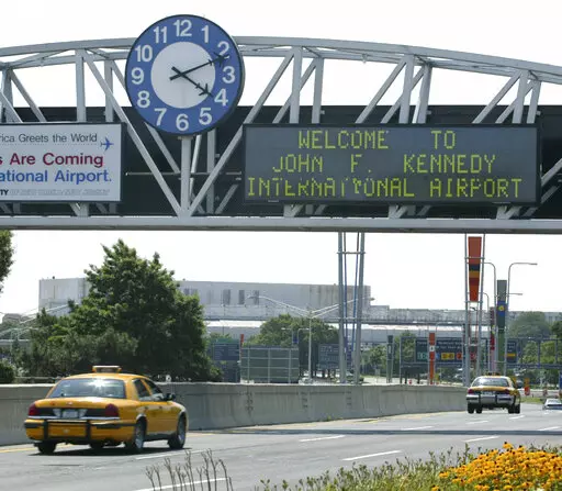 A clock at the entrance to JFK Airport in New York is pictured on Aug. 15, 2003. Officials are investigating a close call at the New York airport that happened Friday, Jan. 13, 2023, between a plane that was crossing a runway and another that was preparing for takeoff. (AP Photo/Stuart Ramson, File)