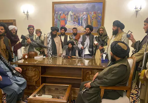 FILE - In this Aug. 15, 2021 file photo, Taliban fighters take control of Afghan presidential palace in Kabul, Afghanistan, after President Ashraf Ghani fled the country. (AP Photo/Zabi Karimi, File)