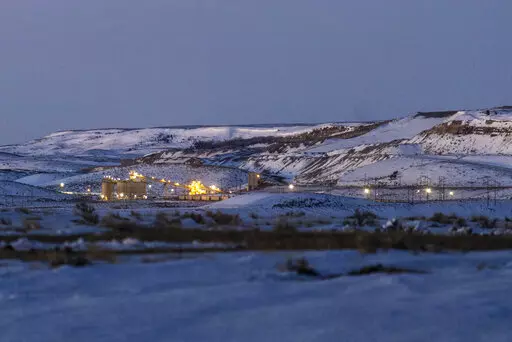Lights illuminate a coal mine at twilight, Jan. 13, 2022, in Kemmerer, Wyo. With the nearby coal-fired Naughton Powerplant being decommissioned in 2025, the fate of the coal mine and its workers is uncertain. More than 500 days into his presidency, Joe Biden's hope for saving the Earth from the most devastating effects of climate change may not be dead. But it's not far from it after a Supreme Court ruling not only limited the Environmental Protection Agency's ability to regulate pollution by po