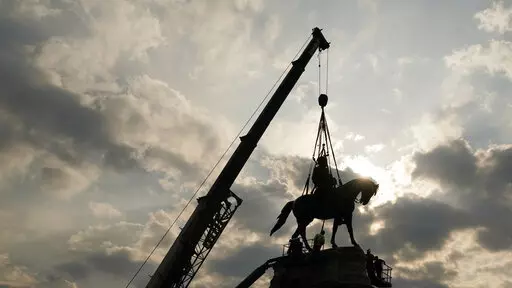 Crews work to remove one of the country's largest remaining monuments to the Confederacy, a towering statue of Confederate Gen. Robert E. Lee on Monument Avenue, Wednesday, Sept. 8, 2021, in Richmond, Va. (AP Photo/Steve Helber, Pool)