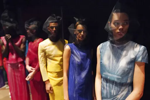 Models appear backstage in preparation for the Thom Browne fashion show during New York Fashion Week at The Shed, on Saturday, Sept. 11, 2021, in New York. (Photo by Charles Sykes/Invision/AP)