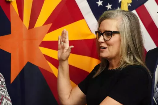 The new Arizona Democratic Gov. Katie Hobbs takes the oath of office in a ceremony at the state Capitol in Phoenix, Monday, Jan. 2, 2023. (AP Photo/Ross D. Franklin, Pool)