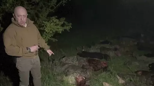 In this handout image taken from a video released by Prigozhin Press Service on Friday, May 5, 2023, head of Wagner Group Yevgeny Prigozhin stands in front of multiple bodies lying on the ground in an unknown location. The owner of Russia's private military company Wagner, Yevgeny Prigozhin, on Friday threatened to pull out Wagner forces from the embattled Ukrainian city of Bakhmut next week, accusing Russia's military command of starving the group of ammunition. (Prigozhin Press Service via AP)