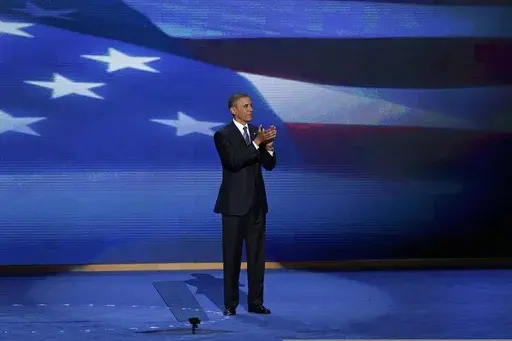 President Barack Obama stands on stage after addressing the Democratic National Convention in Charlotte, N.C., Sept. 6, 2012. (AP Photo/J. Scott Applewhite, File)