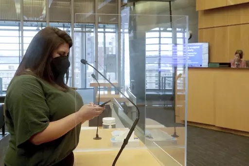Gig worker Danielle Alvorado testifies before the Seattle City Council in support of the city providing permanent sick and safe time to most gig workers in the city, on Tuesday, March 28, 2023, in Seattle. The City Council voted unanimously to make it permanent for “on-demand” gig workers on apps like DoorDash, Postmates and Instacart. (Greg Gilbert/The Seattle Times via AP)