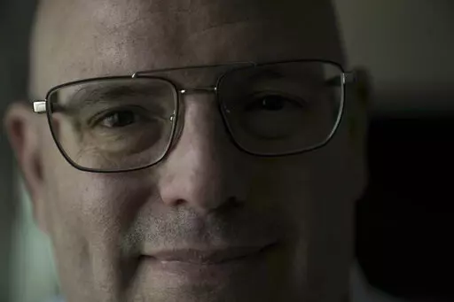 Harel Hershtik pose for a photograph at his labs in Rehovot, Israel, Wednesday, May 11, 2022. When he was 20 years old,  Hershtik planned and executed a murder. Today, he is the brains behind an Israeli health-tech startup, poised to make millions of dollars with the backing of prominent public figures and deep-pocketed investors. (AP Photo/Ariel Schalit)