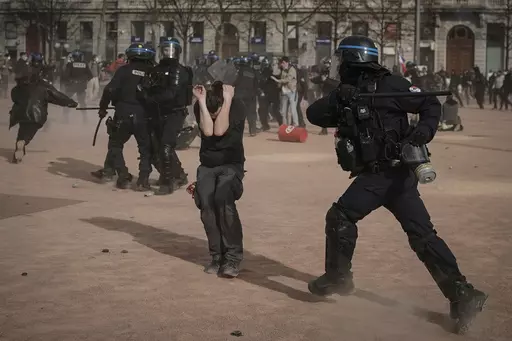 Police officers scuffle with protesters during a demonstration in Lyon, central France, on March 23, 2023. French authorities see the police as protectors ensuring that citizens can peacefully protest President Emmanuel Macron’s contentious retirement age increase. But to human rights advocates and demonstrators who were clubbed or tear-gassed, officers have overstepped their mission. (AP Photo/Laurent Cipriani, File)