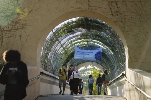 Students cross a bridge linking different sections of the campus, at New College of Florida, Tuesday, Feb. 28, 2023, in Sarasota, Fla. For years, students have come to this public liberal arts college on the western coast of Florida because they were self-described free thinkers. Now they find themselves caught in the crosshairs of America's culture war. (AP Photo/Rebecca Blackwell)