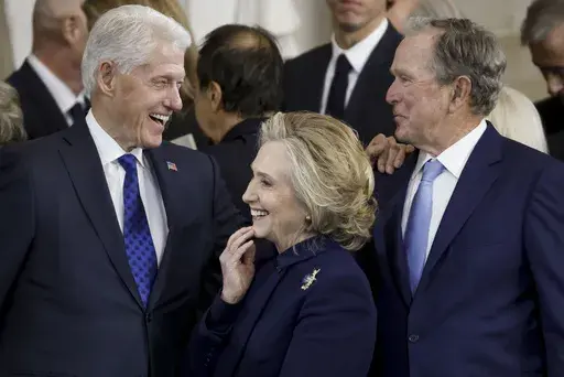 From left, former President Bill Clinton, former Secretary of State Hillary Clinton, and former President George W. Bush, speak following the 60th Presidential Inauguration for President Donald Trump, in the Rotunda of the U.S. Capitol in Washington, Monday, Jan. 20, 2025. (Shawn Thew/Pool photo via AP)