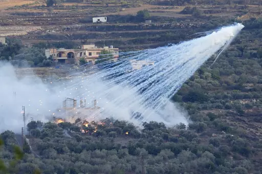 A shell that appears to be white phosphorus from Israeli artillery explodes over a house in al-Bustan, a Lebanese border village with Israel, south Lebanon, on Oct. 15, 2023. The human rights group Amnesty International said Tuesday Oct. 31, 2023 that civilians in southern Lebanon were injured earlier this month when Israeli forces hit a border village with shells containing white phosphorus, a controversial incendiary munition. (AP Photo/Hussein Malla, File)