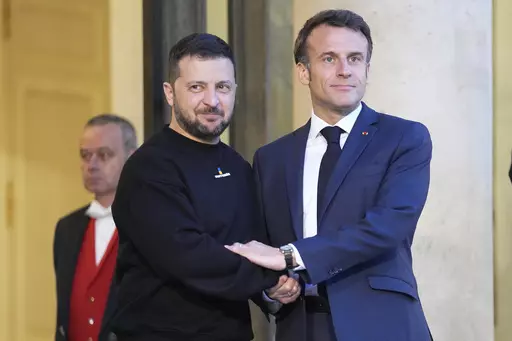 French President Emmanuel Macron, right, welcomes Ukrainian President Volodymyr Zelenskyy at the Elysee palace in Paris, May 14, 2023. French President Emmanuel will sign a bilateral security agreement with Ukrainian President Volodymyr Zelenskyy on Friday Feb.16, 2024 in Paris as part of a trip to Germany and France, the French presidency said in a statement. (AP Photo/Michel Euler, File)