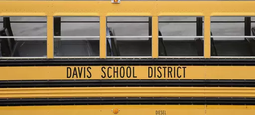 A Davis School District bus sits at the Bus Farm in Farmington, Utah, in this undated photo. A Black woman hired by the northern Utah school district to investigate racial harassment complaints a year after a 10-year-old Black student died by suicide says that she, too, experienced discrimination from district officials. Joscelin Thomas, a former coordinator in the Davis School District's equal opportunity office, alleges in a federal lawsuit that district administrators treated her “as if she