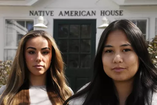 Dartmouth College students Marisa Joseph, right, a member of the Tulalip Tribes of Washington, poses with Ahnili Johnson-Jennings, left, a member of the Quapaw, Choctaw, Sac and Fox and Miami tribes, pose outside the Native American House at Dartmouth College, Friday, April 7, 2023, in Hanover, N.H. The college announced in March 2023 that it housed partial Native American skeletal remains in their collection. Dartmouth has set in motion an effort to repatriate the remains to the appropriate tri