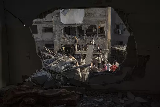 Palestinians look at the destruction after Israeli strikes on the Gaza Strip in Khan Younis, Saturday, Now. 4, 2023. (AP Photo/Fatima Shbair)