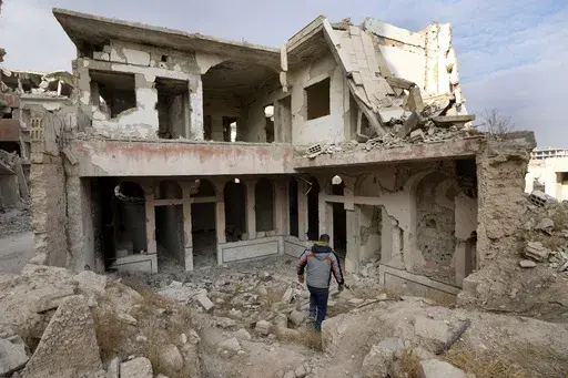 A Syrian man observes the destroyed Jobar Synagogue, also known as Eliyahu Hanavi, in Jobar neighborhood, in Damascus, Syria, Saturday, Dec. 21, 2024. (AP Photo/Hussein Malla)