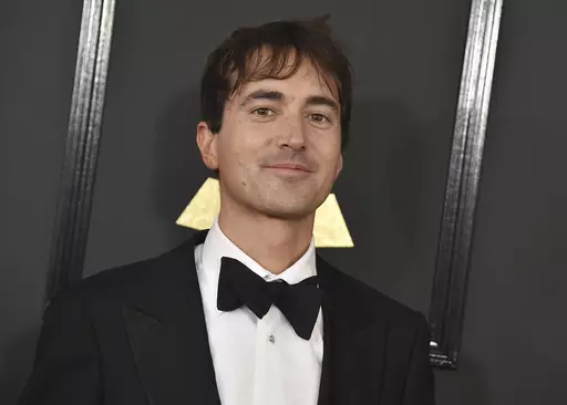 Mason Bates arrives at the 59th annual Grammy Awards at the Staples Center on Sunday, Feb. 12, 2017, in Los Angeles. The Los Angeles Opera scrapped plans for the world premiere of Bates' “The Amazing Adventures of Kavalier & Clay” this fall because of finances, and the work will instead open with a student cast at Indiana University's Jacobs School of Music. (Photo by Jordan Strauss/Invision/AP, File)