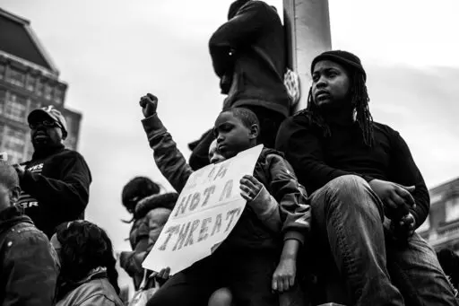 Residents of Baltimore gather during the community’s response to the 2015 in-custody death of Freddie Gray. The photo is part of a collection called “the Impact of Images” collection curated by Lead With Love, in collaboration with the studio and production company behind the film “Till.”  (Devin Allen via AP)