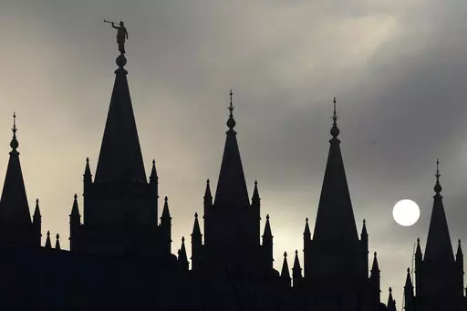 The angel Moroni statue atop the Salt Lake Temple is silhouetted against a cloud-covered sky, at Temple Square in Salt Lake City on Feb. 6, 2013. (AP Photo/Rick Bowmer, File)
