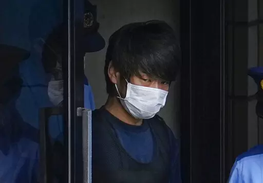 Tetsuya Yamagami, the alleged assassin of Japan's former Prime Minister Shinzo Abe, exits a police station in Nara, western Japan, on July 10, 2022, on his way to local prosecutors' office. Yamagami is expected to face murder charges Friday, Jan. 13, 2023, in Japan's highest profile case in recent years. (Nobuki Ito/Kyodo News via AP, File)