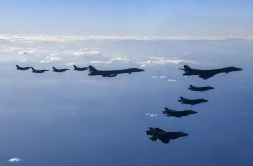 In this photo provided by South Korean Defense Ministry, two U.S. Air Force B-1B bombers, top center, four South Korean Air Force F-35 fighter jets and four US Air Force F-16 fighter jets fly over South Korea Peninsula during a joint air drill called "Vigilant Storm," in South Korea, Saturday, Nov. 5, 2022. North Korea added to its recent barrage of weapons demonstrations by launching four ballistic missiles into the sea on Saturday, as the United States sent two supersonic bombers streaking ove