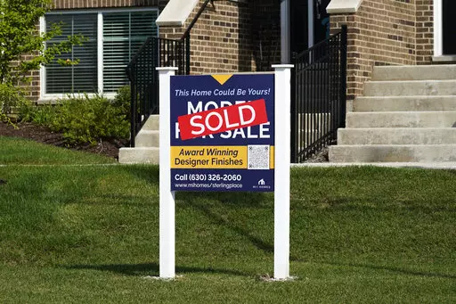 An advertising sign for building land stands in front of a new home construction site in Northbrook, Ill., Wednesday, Sept. 21, 2022.  Elevated home prices, rising interest rates and steep competition are interrupting millennials’ plans to get that quintessential piece of the American dream — their first home, or an upgrade from a small starter home. If you were planning on buying a home over the past year or so, you may have started the process by getting a mortgage preapproval and working 