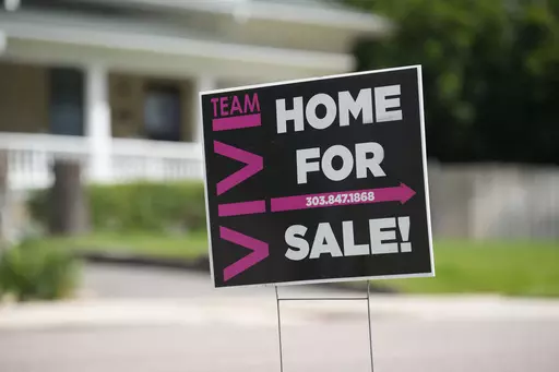 A for sale sign stands outside a single-family residence on Sunday, June 18, 2023, in Denver. On Thursday, Freddie Mac reports on this week's average U.S. mortgage rates. (AP Photo/David Zalubowski)
