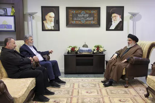 In this photo released on Wednesday, Oct. 25, 2023, by the Hezbollah Media Relations Office, Hezbollah leader Sayyed Hassan Nasrallah, right, meets with Ziad al-Nakhleh, the head of Palestinian Islamic Jihad, center, and Hamas deputy chief, Saleh al-Arouri, in Beirut, Lebanon. Nasrallah met with top Hamas and Palestinian Islamic Jihad officials, their first reported meeting since the Hamas-Israel war erupted earlier this month and clashes began along the Lebanon-Israel border. (Hezbollah Media R