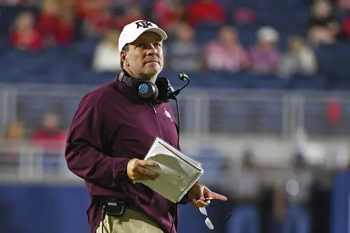 Texas A&M head coach Jimbo Fisher watches during the first half of an NCAA college football game against Mississippi in Oxford, Miss., Saturday, Oct. 19, 2019. After Texas A&M added yet another blue-chipper to the highest-rated recruiting class in college football Wednesday, Feb. 2, 2022 coach Jimbo Fisher went off about rumors that booster-funded NIL deals were fueling the Aggies' success.(AP Photo/Thomas Graning, File)