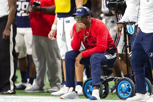 Jackson State head coach Deion Sanders watches on the sideline during the first half of the Cricket Celebration Bowl NCAA college football game against South Carolina State on Saturday, Dec. 18, 2021, in Atlanta. Deion Sanders had two toes on his left foot amputated due to blood clots stemming from a previous surgery. The Jackson State head coach and NFL Hall of Famer revealed the severity of his foot injury in an upcoming episode of his “Coach Prime” documentary series that will air Tuesday