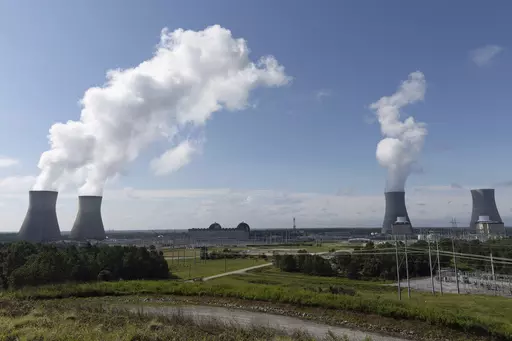 Nuclear reactors and cooling towers of the four units of Plant Vogtle, a nuclear plant near Waynesboro, Ga., are shown on July 31, 2023. Georgia Power Co. announced Thursday, Aug. 17, 2023, that Unit 4, at far right, is loading fuel, with the aim of sending power to the grid reliably by March 2024. Unit 4 and the now-operating Unit 3 and Unit 4 are the first new American reactors built from scratch in decades. (Arvin Temkar/Atlanta Journal-Constitution via AP, File)