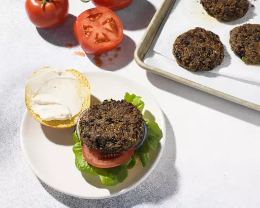 This image released by Milk Street shows a recipe for quinoa and black bean burgers. (Milk Street via AP)