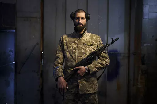 Sergiy Volosovets, 30, actor-turned-commander with the Territorial Defense Forces, poses for a photo in Brovary, on the outskirts of Kyiv, Ukraine, Wednesday, March 30, 2022. Volosovets now commands a unit of 11 men and oversees the military training of other volunteers at a base northeast of the capital, Kyiv. They are old, young, local, foreign, often new to war. Thousands of people have volunteered to join Ukraine’s Territorial Defense Forces and resist Russia’s invasion. The Associated P