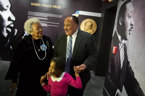 Martin Luther King III, right, the son of Rev. Martin Luther King Jr., walks with his daughter Yolanda, and Naomi King, left, the wife of Rev. King's brother, A.D., through an exhibition devoted to the awarding of the Nobel Peace Prize to King at the Martin Luther King Jr. Historical Site, Wednesday, Dec. 10, 2014, in Atlanta. Civil rights activist Naomi Barber King died Thursday, March 7, 2024, in Atlanta, according to family members. She was 92. (AP Photo/David Goldman, File)