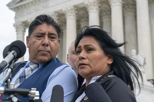 Beatriz Gonzalez, right, the mother of 23-year-old Nohemi Gonzalez, a student killed in the Paris terrorist attacks, and stepfather Jose Hernandez, speak outside the Supreme Court, Feb. 21, 2023, in Washington. The Supreme Court on Thursday, May 18, sidestepped a case against Google that might have allowed more lawsuits against social media companies. The justices' decision returns to a lower court the case from the family of Nohemi Gonzalez. The family wants to sue Google for YouTube videos the