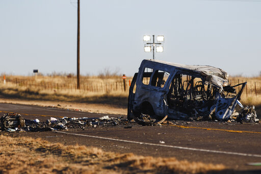 CORRECTS DAMAGE TO VAN FROM BUS - The damage van sits on the side of the road at the scene of a fatal car wreck early Wednesday, March 16, 2022 half of a mile north of State Highway 115 on Farm-to-Market Road 1788 in Andrews County, Texas. A pickup truck crossed the center line of a two-lane road in Andrews County, about 30 miles (50 kilometers) east of the New Mexico state line on Tuesday evening and crashed into a van carrying members of the University of the Southwest men's and women's golf t